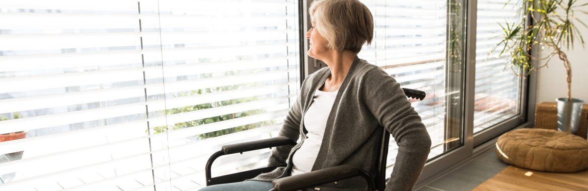 disabled-senior-woman-in-wheelchair-at-home-in-her-living-room-looking-out-the-window-wininpeg