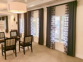 Sheer roller shades and drapes in a Winnipeg assisted living home